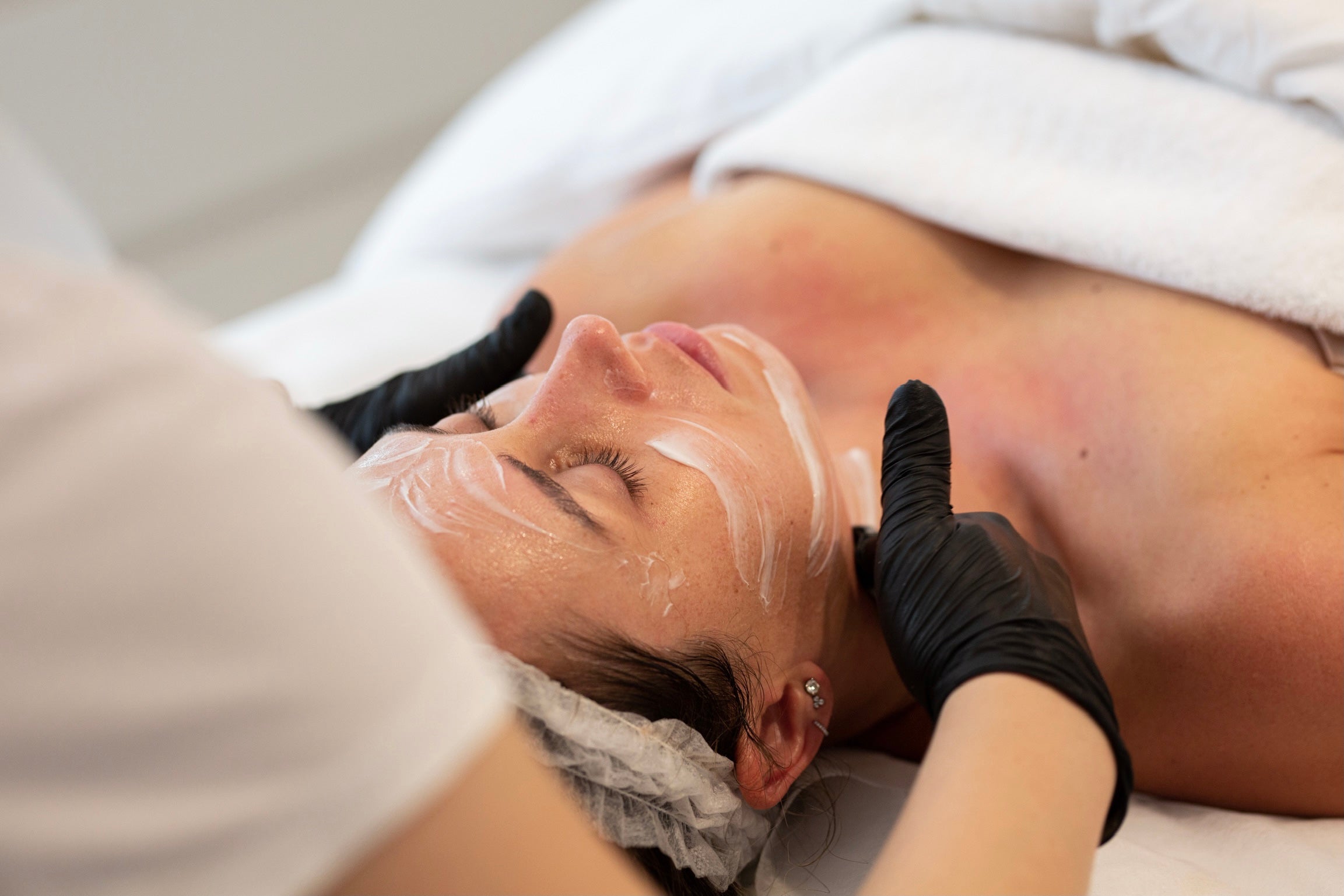 A female client receiving gentle face cleanse as part of the preparation for Sculptra Dubai to ensure a clean, fresh, radiant face
