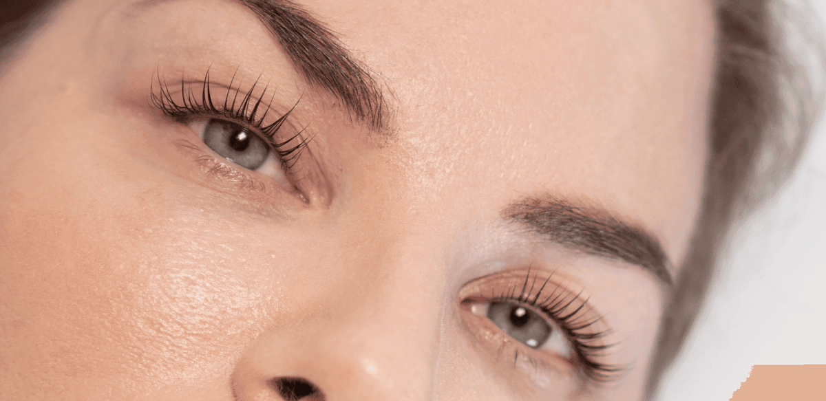 A woman’s eyes after Korean lash lift treatment, looking naturally lifted, defined, voluminous, and glossy.