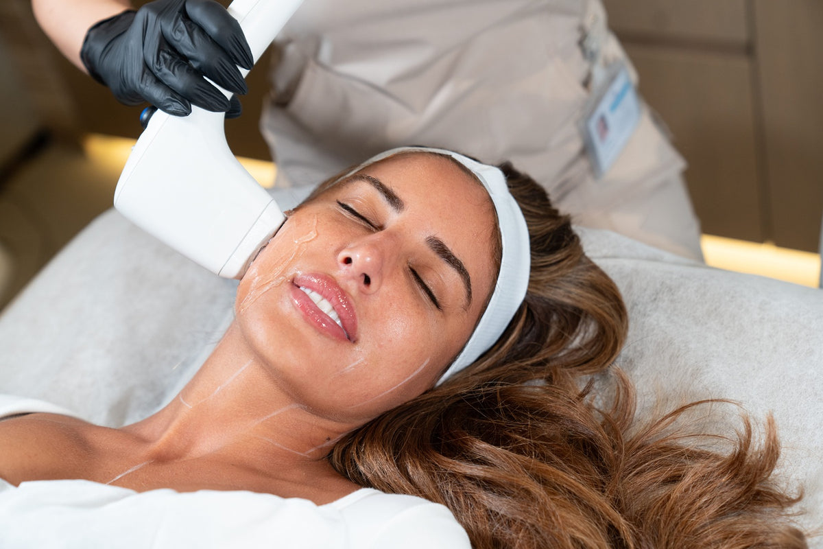 Sofwave ultrasound facial treatment being performed on a woman's face to tighten and rejuvenate the skin.