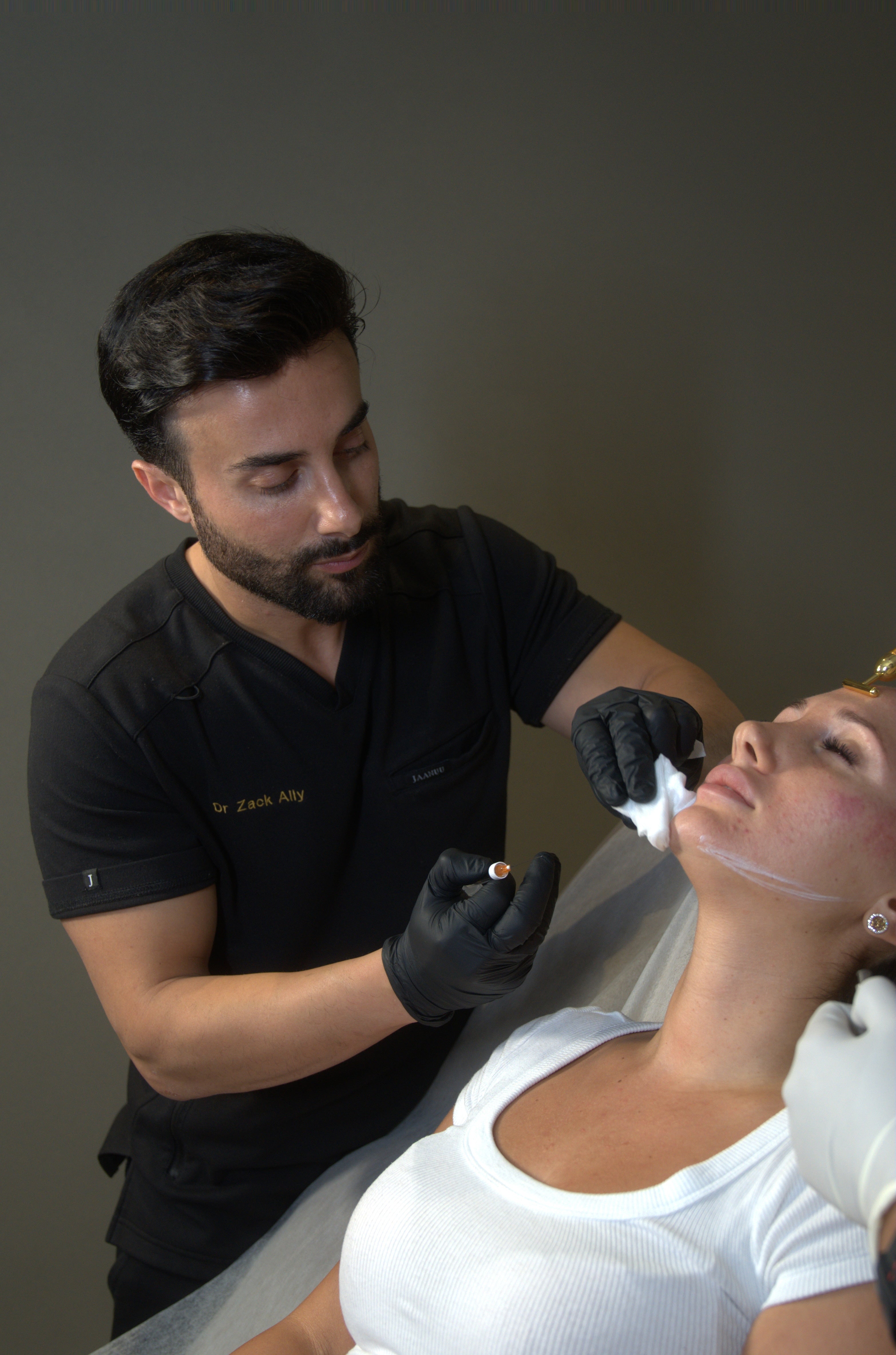Dr. Zack doing refinements on clients face