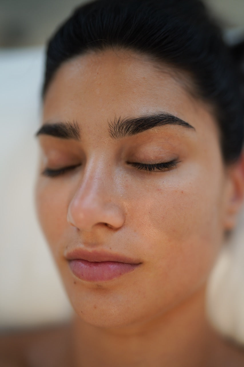 A clear close look of a woman's glowing skin post-treatment of Sculptra injections on face done by a specialist at BROWZ in Dubai.
