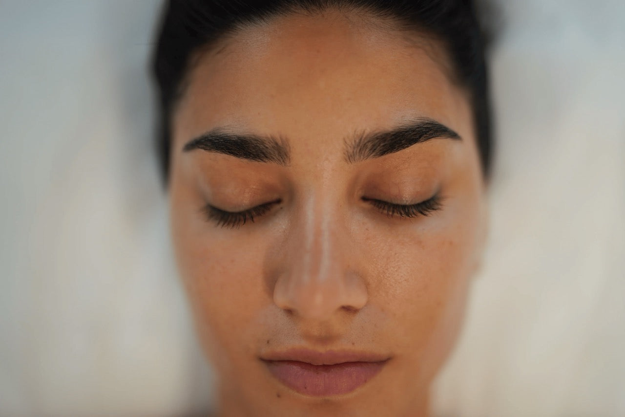A clear close look of a woman's glowing skin after Sculptra injections on the face done by experts at BROWZ in Dubai.
