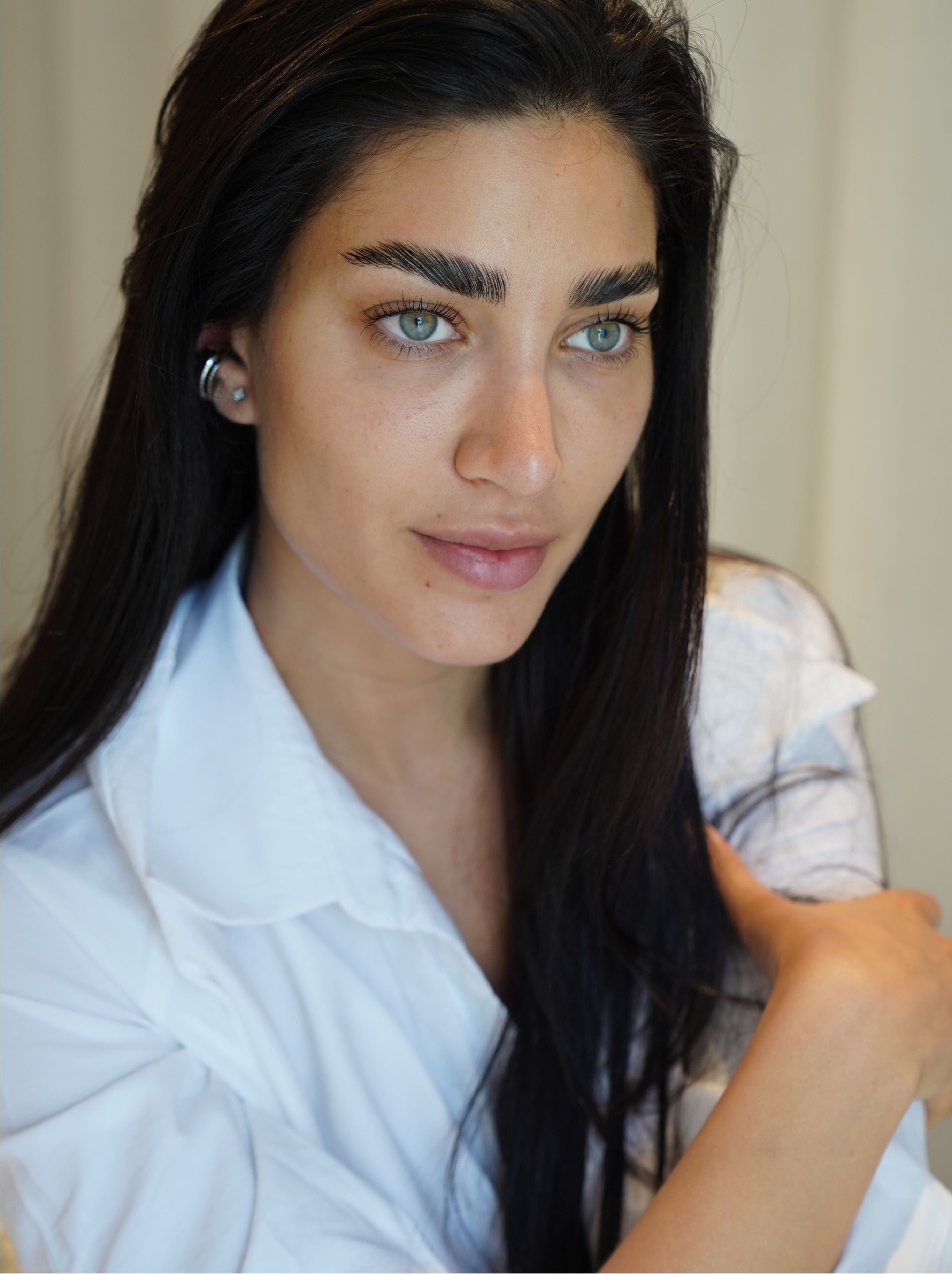 Close-up look of a woman's radiant skin, representing the glow achieved after Radiesse dermal filler done by BROWZ Dubai.