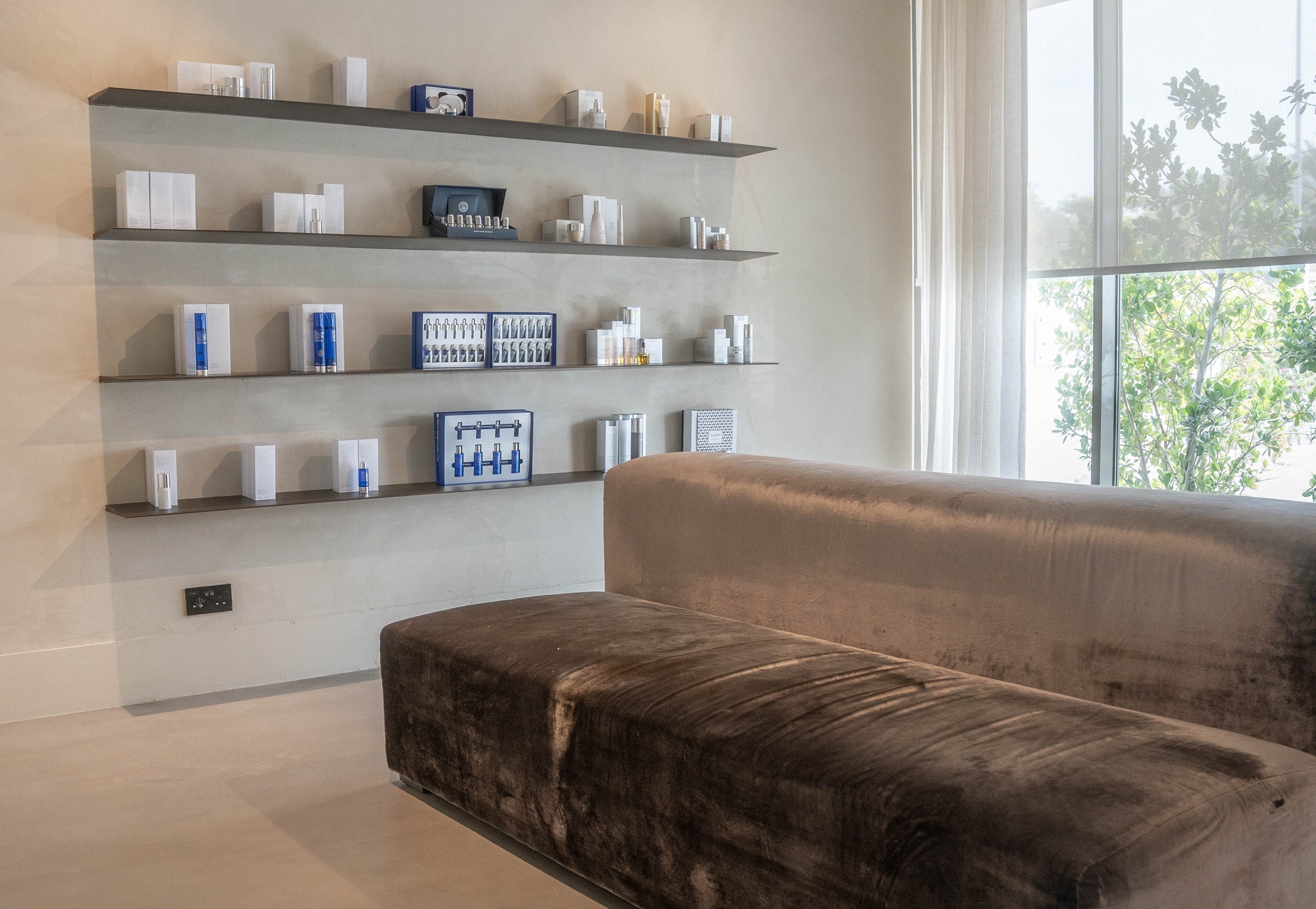 Modern skincare is displayed in a luxury aesthetic clinic interior.