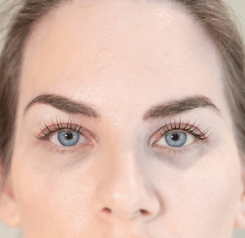 Korean lash lift treatment, with a woman after the session, showing beautifully curled, long, natural, & enhanced lashes in Dubai.