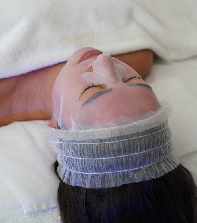 Exosome treatment aftercare, applying a soothing serum or cooling mask to calm the skin and provide aftercare advice for healing.
