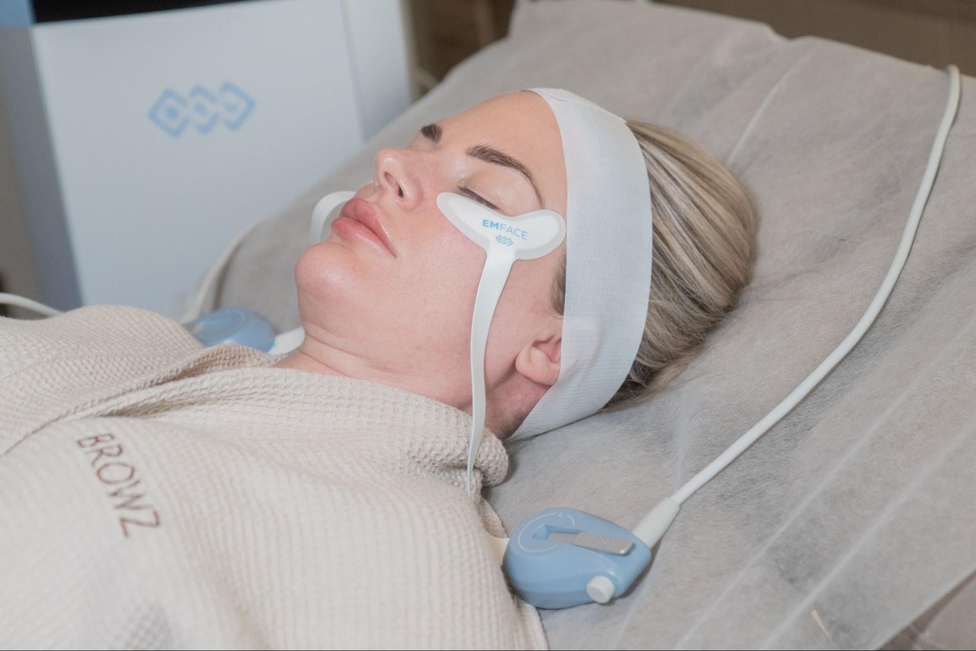 A woman undergoing EMFace treatment at BROWZ in Dubai, carefully receiving a undereye lift for a firmer, smoother look