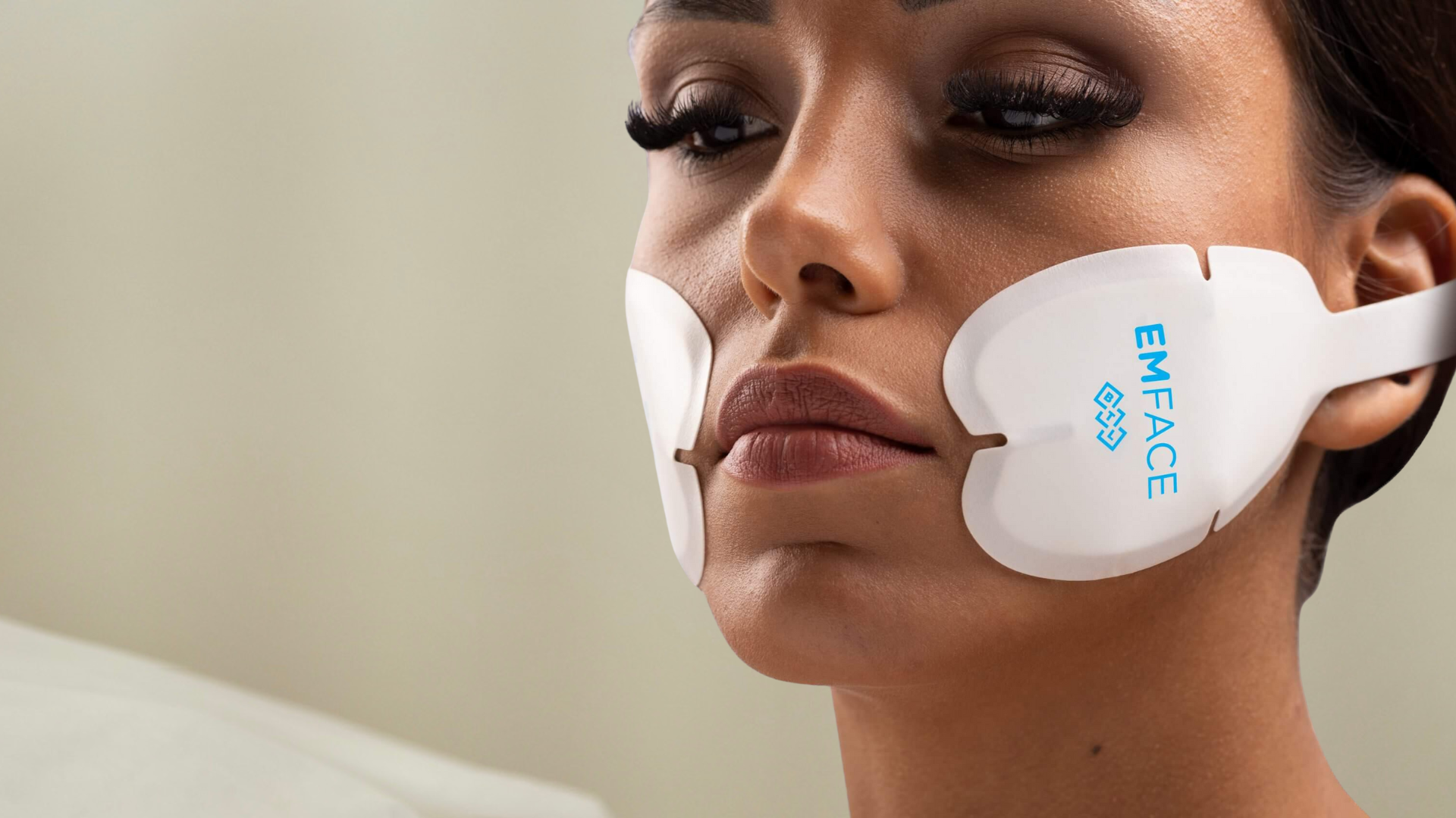A woman with EMFace treatment patch to to boost collagen and elastin. To tone muscles and lift the skin naturally at BROWZ Dubai.