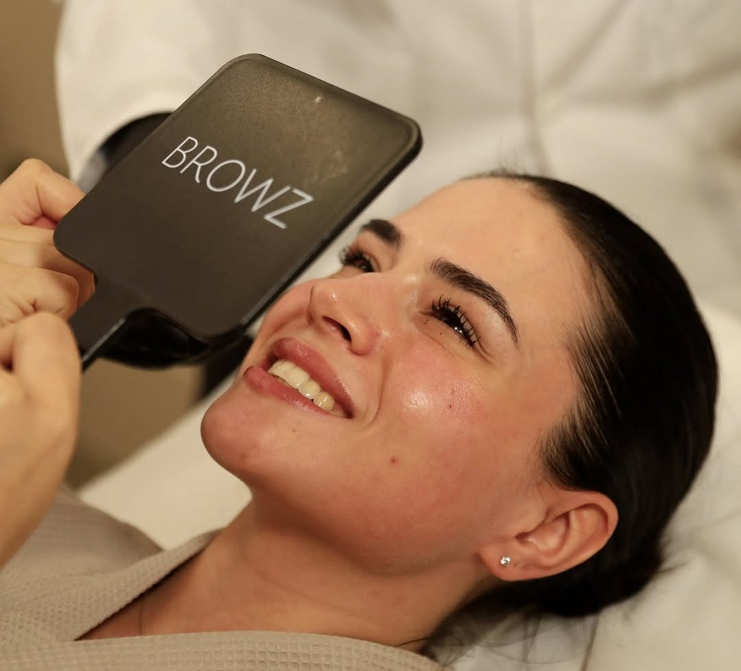 Client glowing with joy after her beauty treatment.
